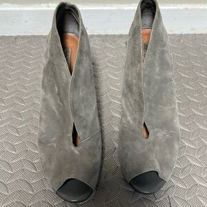 Soft suede. Beautiful shoes just a bit too tall for me.